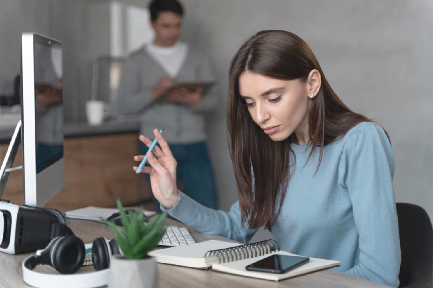 Students working collaboratively on financial analysis projects with laptops and documents